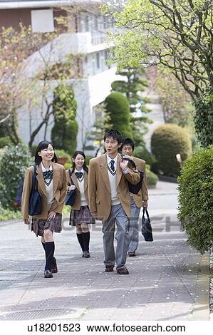 Stock Image - High School Students Walking on Street Together. Fotosearch