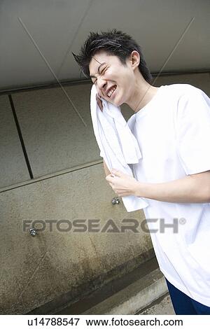 Teenage boy in gym cloth drying face with towel View Large Photo Image Stock Photo - Teenage boy in gym cloth drying face with towel. Fotosearch