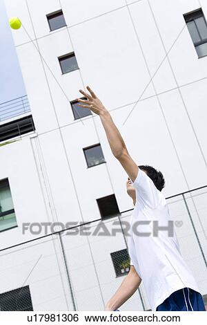 Teenage boy serving tennis ball View Large Photo Image Stock Photograph - Teenage boy serving tennis ball. Fotosearch