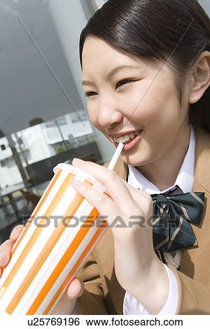 Teenage girl smiling and drinking at terrace View Large Photo Image Stock Photograph - Teenage girl smiling and drinking at terrace. Fotosearch