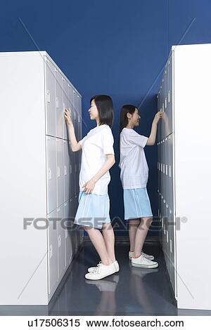 Teenage girls in gym clothes standing in locker room View Large Photo Image Stock Photography - Teenage girls in gym clothes standing in locker room. Fotosearch