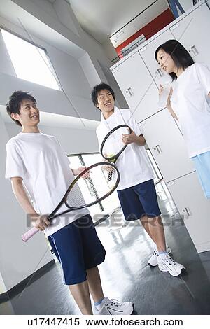 Three teenagers in locker room, boys holding tennis ball and rackets View Large Photo Image Stock Photography - Three teenagers in locker room, boys holding tennis ball and rackets. Fotosearch