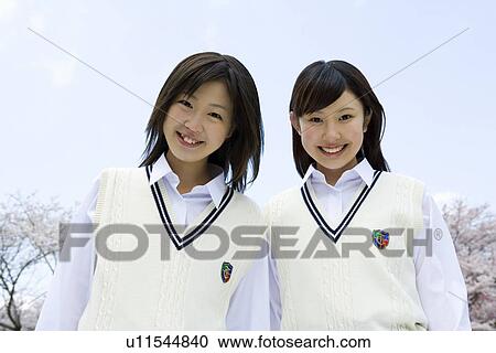 Stock Image - Two High School Girls Smiling at Camera. Fotosearch