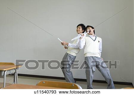 Stock Image - Two high school students practicing stage performance. Fotosearch