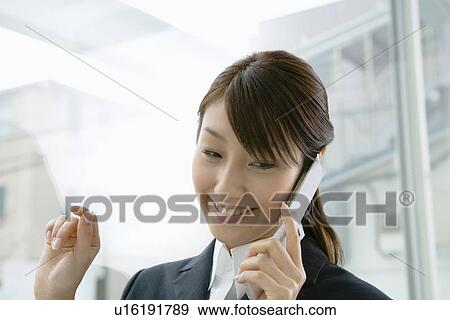 Stock Photo - Businesswoman on a Mobile Phone, Head and Shoulder, Front View. Fotosearch
