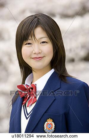 Picture - High School Girl Showing Mobile Phone to Friends. Fotosearch