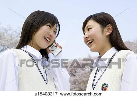 Stock Photo - High School Girl Talking on Mobile Phone in Outside. Fotosearch