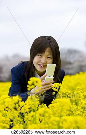 Stock Photography - High School Student Taking Picture with Mobile Phone, Differential Focus. Fotosearch