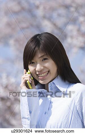 Picture - Young Woman Talking on Mobile Phone, Differential Focus, Front View . Fotosearch