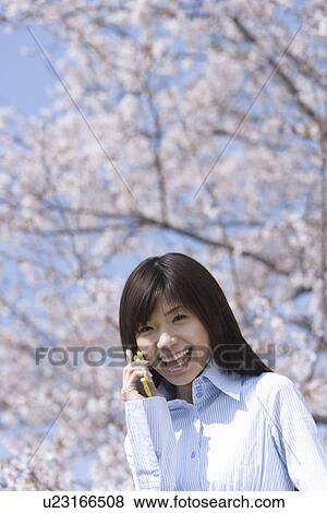 Young Woman Talking on Mobile Phone, Low Angle View View Large Photo Image Stock Photo - Young Woman Talking on Mobile Phone, Low Angle View. Fotosearch