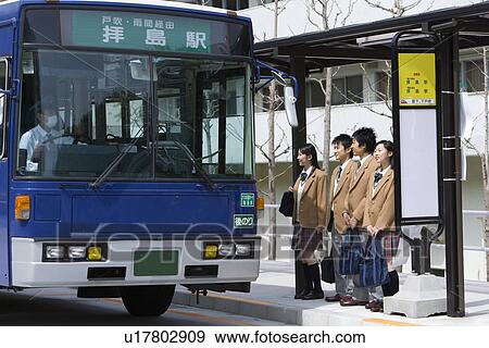 Four high school students standing at bus stop View Large Photo Image Stock Photo - Four high school students standing at bus stop. Fotosearch