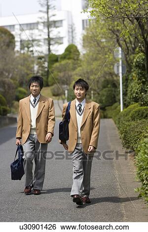 Stock Photograph - High School Boys Walking on Street to Home. Fotosearch