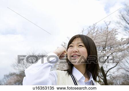 High School Girl In Front Of Cherry Blossoms View Large Photo Image Stock Photography - High School Girl In Front Of Cherry Blossoms. Fotosearch