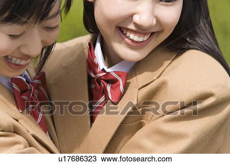 Stock Image - High School Girls Hugging and Smiling. Fotosearch