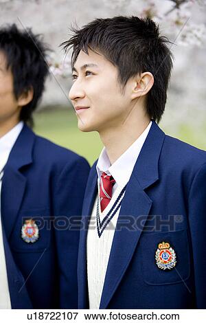 Stock Photo - High School Student In Front Of Cherry Blossoms, Differential Focus. Fotosearch
