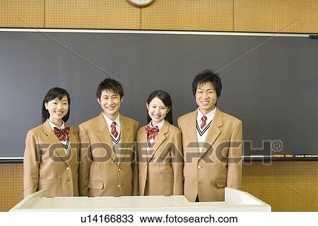 Stock Image - High School Students Standing and Smiling in front of Blackboard. Fotosearch