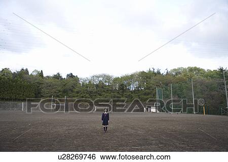 Stock Photograph - Portrait of a teenage girl standing in schoolyard. Fotosearch