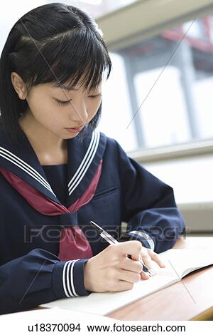 Teenage girl studying at desk View Large Photo Image Picture - Teenage girl studying at desk. Fotosearch