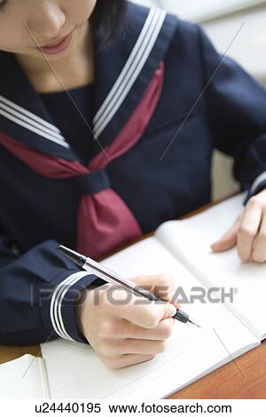 Stock Photography - Teenage girl studying at desk. Fotosearch