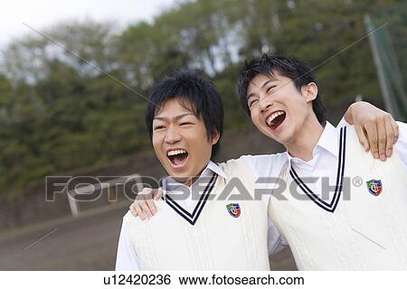 Two teenage boys putting arms around each other and yelling View Large Photo Image Stock Photograph - Two teenage boys putting arms around each other and yelling. Fotosearch