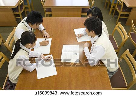 Four teenagers studying in library View Large Photo Image Stock Image - Four teenagers studying in library. Fotosearch