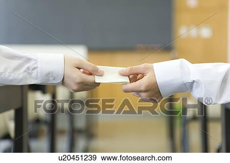 High school students passing memo during class View Large Photo Image Stock Photo - High school students passing memo during class. Fotosearch