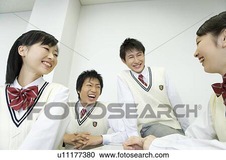 High school students sitting at desk and talking in classroom View Large Photo Image Stock Image - High school students sitting at desk and talking in classroom. Fotosearch