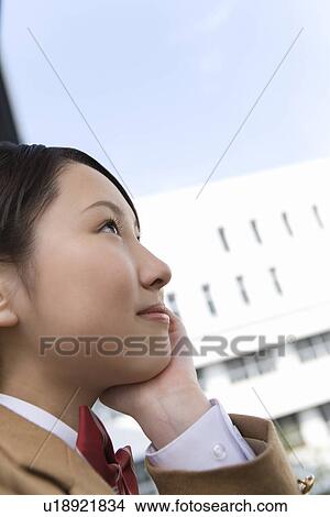 Teenage girl resting chin in hand, smiling View Large Photo Image Picture - Teenage girl resting chin in hand, smiling. Fotosearch