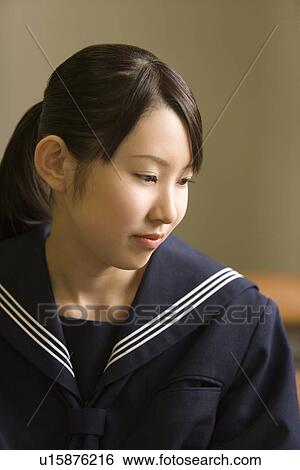 Teenage girl sitting at desk in classroom View Large Photo Image Stock Photograph - Teenage girl sitting at desk in classroom. Fotosearch