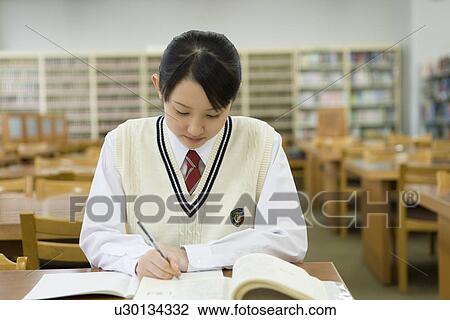 Teenage girl studying in library View Large Photo Image Stock Image - Teenage girl studying in library. Fotosearch