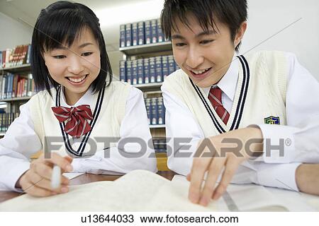 Two teenagers studying in library, smiling View Large Photo Image Stock Image - Two teenagers studying in library, smiling. Fotosearch