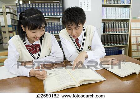 Two teenagers studying in library, smiling View Large Photo Image Stock Image - Two teenagers studying in library, smiling. Fotosearch