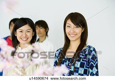 Portrait of four young people with cherry flowers, smiling and looking at camera, front view, white background View Large Photo Image Picture - Portrait of four young people with cherry flowers, smiling and looking at camera, front view, white background. Fotosearch