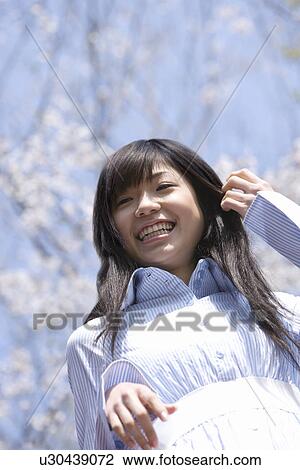 Young Woman and Cherry Blossom in the Background, Low Angle View View Large Photo Image Stock Image - Young Woman and Cherry Blossom in the Background, Low Angle View. Fotosearch