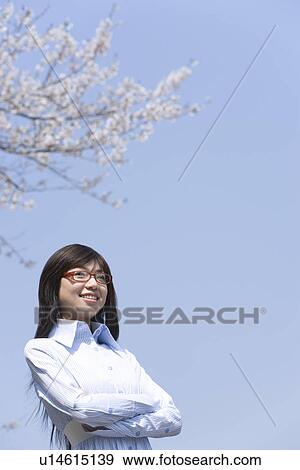 Young Woman Wearing Glasses under Cherry blossoms, Low Angle View, Copy Space View Large Photo Image Stock Photo - Young Woman Wearing Glasses under Cherry blossoms, Low Angle View, Copy Space. Fotosearch