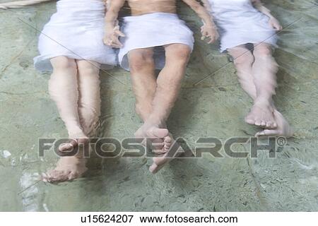 Man and women relaxing in hot tub, hand in hand, high angle view, Japan View Large Photo Image Stock Photo - Man and women relaxing in hot tub, hand in hand, high angle view, Japan. Fotosearch