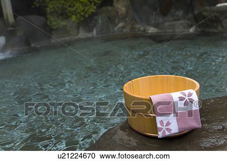 Stock Image - Towel on a wooden tub, hot spring, high angle view, Japan. Fotosearch