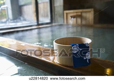 Stock Image - Towel on a wooden tub, hot spring, high angle view, Japan. Fotosearch