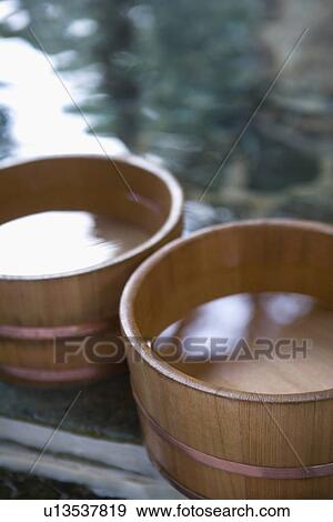 Stock Photo - Two wooden tubs filled with water, hot spring, high angle view, close up, differential focus, Japan. Fotosearch