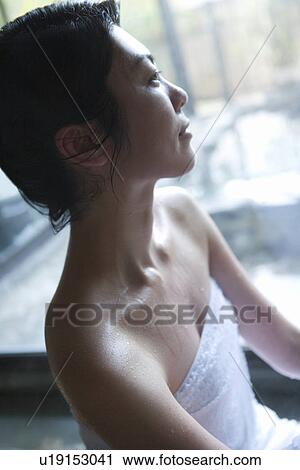 Stock Image - Woman in a hot tub, side view, Japan. Fotosearch