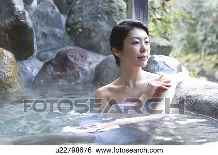 Stock Photograph - Woman in the hot tub, front view, Japan. Fotosearch