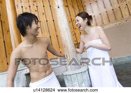 Picture - Young couple smiling in hot tub, front view, side view, Japan. Fotosearch