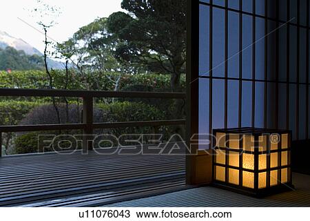 Stock Image - Lighted Lamp in a Japanese Style Room. Fotosearch