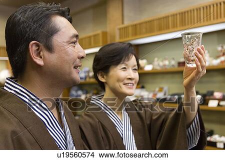 Mature Adult Couple in Yukata Looking For Souvenirs, Side View, Head and Shoulder, Differential Focus View Large Photo Image Picture - Mature Adult Couple in Yukata Looking For Souvenirs, Side View, Head and Shoulder, Differential Focus. Fotosearch