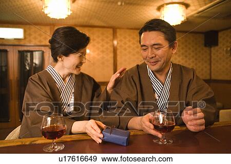 Mature Adult Woman Giving a Present to Her Husband View Large Photo Image Stock Photo - Mature Adult Woman Giving a Present to Her Husband. Fotosearch