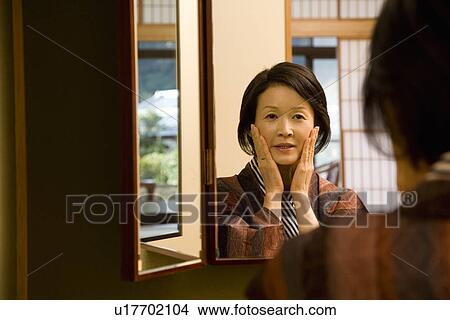 Mature Adult Woman Reflected in a Mirror, Front View, Head and Shoulder View Large Photo Image Picture - Mature Adult Woman Reflected in a Mirror, Front View, Head and Shoulder. Fotosearch