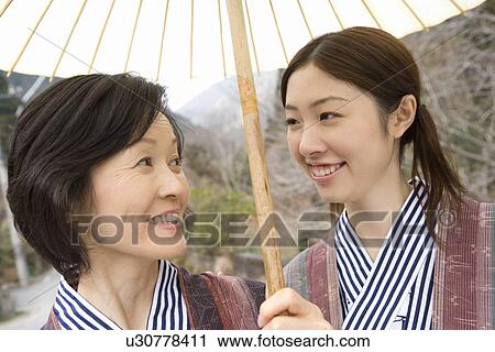 Mother and Daughter Sharing a Paper Umbrella, Front View, Head and Shoulder View Large Photo Image Stock Image - Mother and Daughter Sharing a Paper Umbrella, Front View, Head and Shoulder. Fotosearch