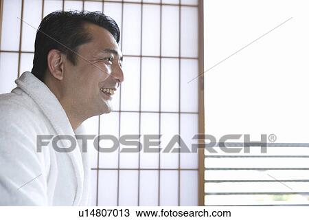 Stock Image - Side View of a Mature Adult Man in a Bathrobe, Head and Shoulder. Fotosearch