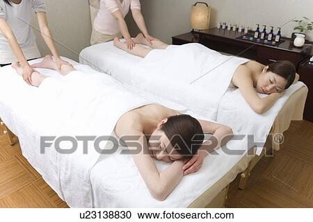 Stock Image - Two women taking massage, high angle view, Japan. Fotosearch