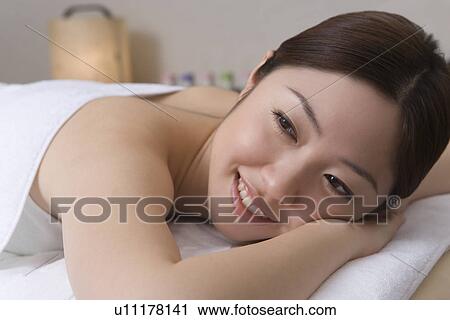 Woman lying on bed in beauty salon, side view, Japan View Large Photo Image Stock Image - Woman lying on bed in beauty salon, side view, Japan. Fotosearch